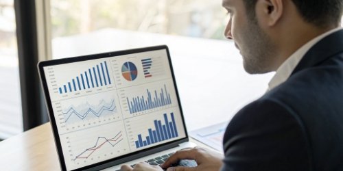Data-Driven Management Benefits A manager looking at a dashboard with real-time profit and cost analysis charts.