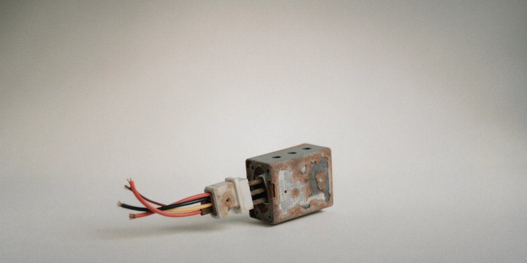 A close-up of a corroded load cell from a standard electronic scale