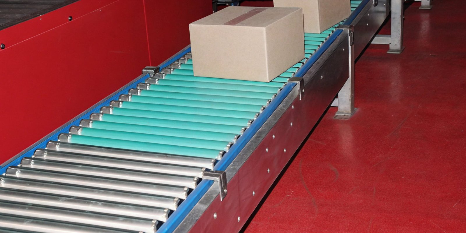 A roller checkweigher integrated into a conveyor belt, weighing boxes automatically.
