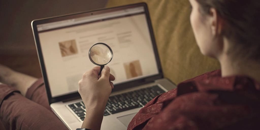 A person using a magnifying glass to inspect a company's website for "R&D" and "Customization"