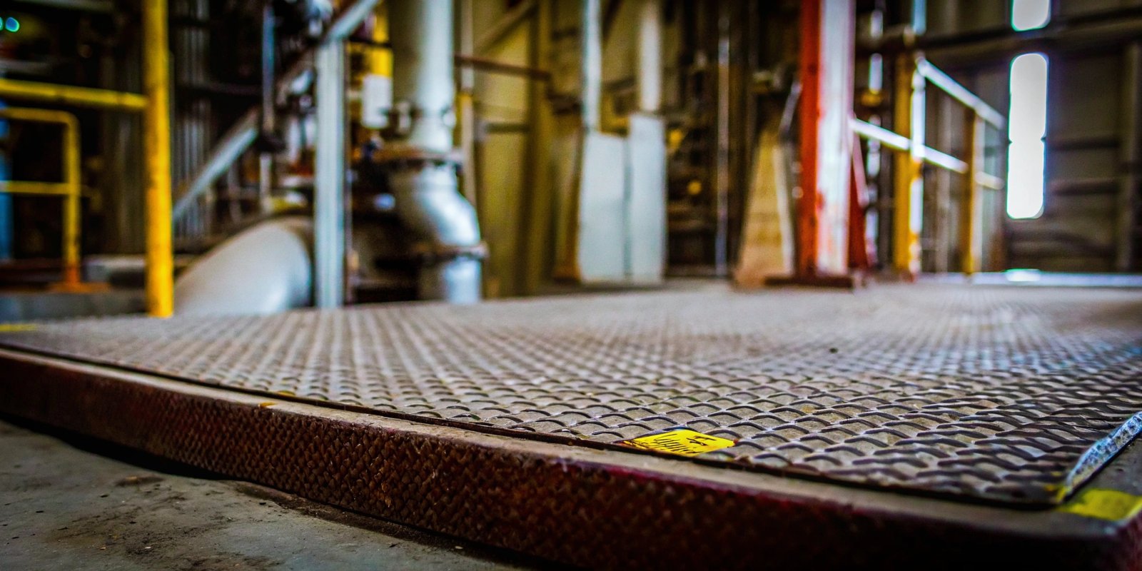 An industrial floor scale with a "Hazardous Area Approved" sticker visible on its indicator.