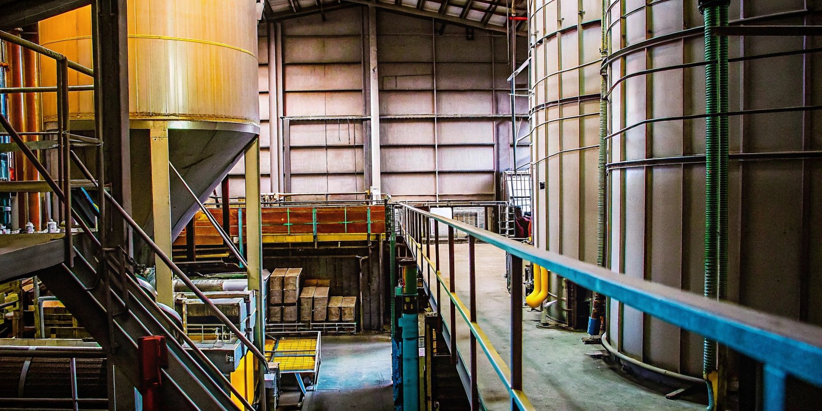 A panoramic view of a food processing plant, highlighting different zones like mixing, packaging, and storage.